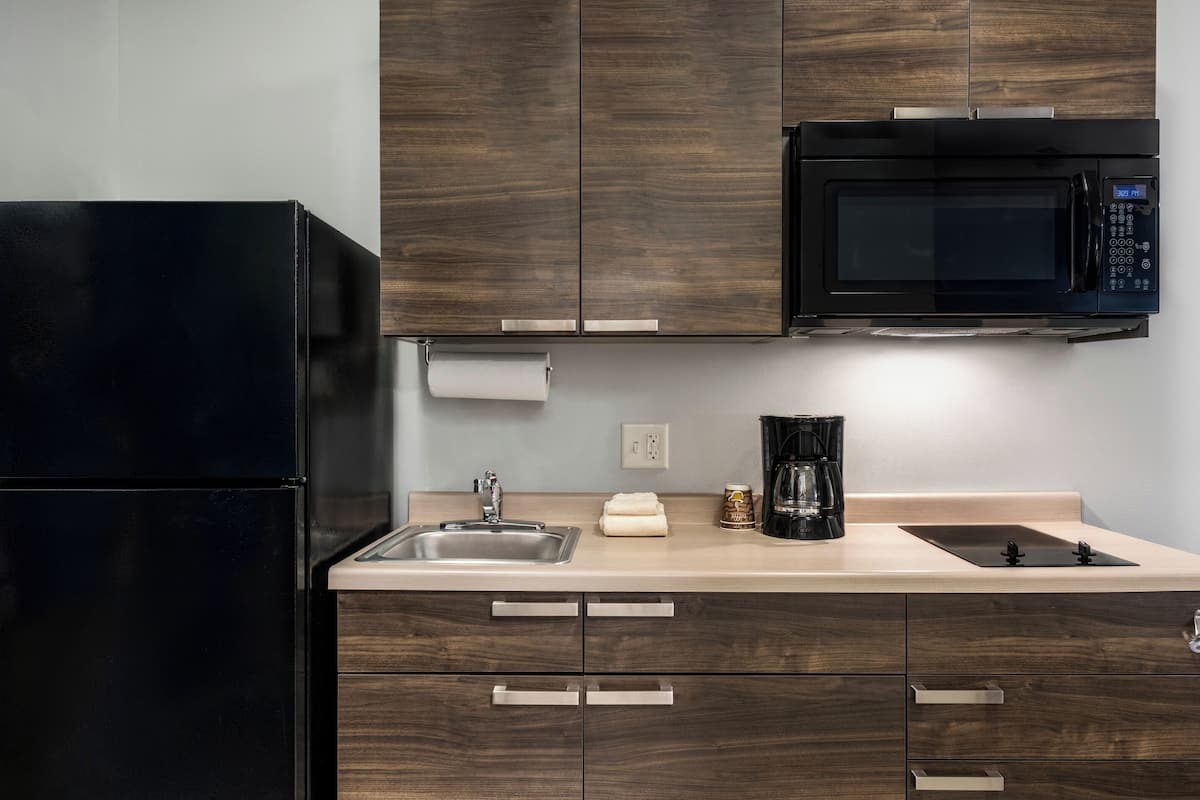 full-sized fridge, microwave, stovetop, coffee/tea maker