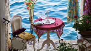 A narrow stone pathway leading to a table with a red tablecloth, a chair, and a vase of flowers. A lamp hangs on the wall, and a wooden bench is visible. - Apartment in Rovinj with Balcony, Air condition, WIFI, Dishwasher (4286-3) (Rovinj)