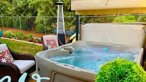 A hot tub with a cover, surrounded by outdoor furniture and a 'Welcome' sign. - Sedona Red Rock Garden of Paradise, Pets friendly and Hot Tub (Sedona)