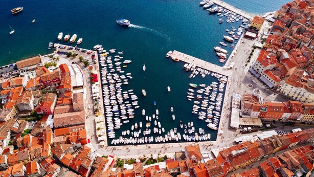 An aerial view of a coastal town with a marina filled with boats, surrounded by densely packed buildings with red-tiled roofs. - Apartment in Rovinj with Terrace, Air condition, WIFI, Dishwasher (4285-2) (Rovinj)