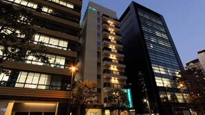 A modern hotel with multiple floors, large windows, and illuminated signage. - Keikyu EX Inn Akihabara (Tokyo)
