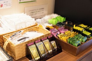 A display of various packaged products, including olive energy and other items, arranged in baskets and boxes.