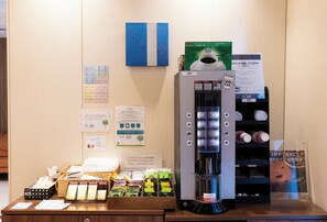 A coffee machine with multiple options, a coffee cup, and a sign that says "Welcome Coffee".