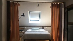 A bedroom with a bed, a window with curtains, a desk with a lamp, and a wardrobe. - Sommerhof in the beautiful Havelland (Märkisch Luch OTBuschow)