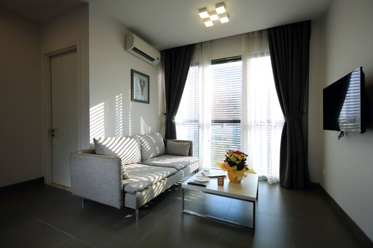 A modern living room with a sofa, a coffee table, and a TV.