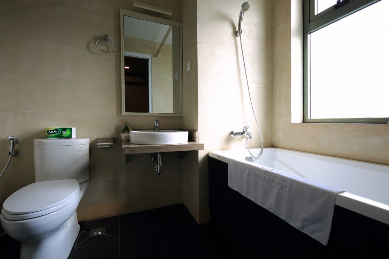 A bathroom with a toilet, sink, and bathtub.