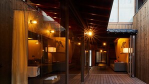 A wooden interior with glass walls, a wooden floor, and a ceiling with star-shaped lights. - Rinn Premium Machiya Townhouse Kyoto Nijo Castle North (Kyoto)