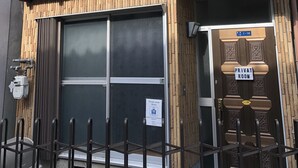 A two-story building with a balcony, a large window, and a sign indicating a private room. - Private room ROSSO (Osaka)