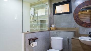 Un baño moderno con inodoro, ducha y lavamanos.