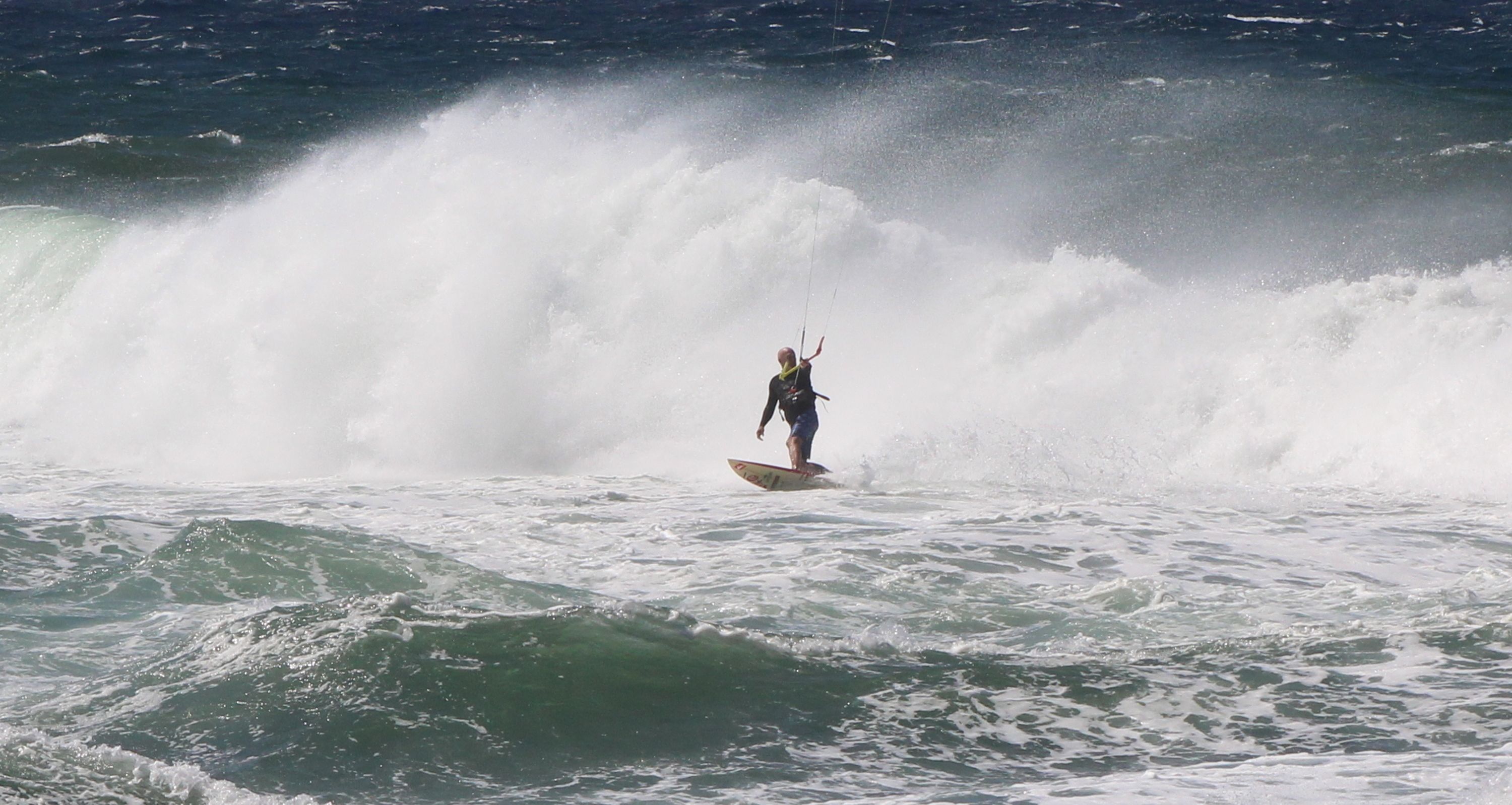 A surfer riding a wave in the ocean.