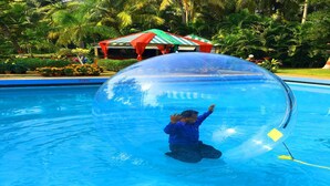 A person inside a transparent ball in a swimming pool. - Toshali Sands Nature Escape (Puri)