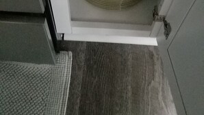 A storage cabinet with a stack of plates inside.