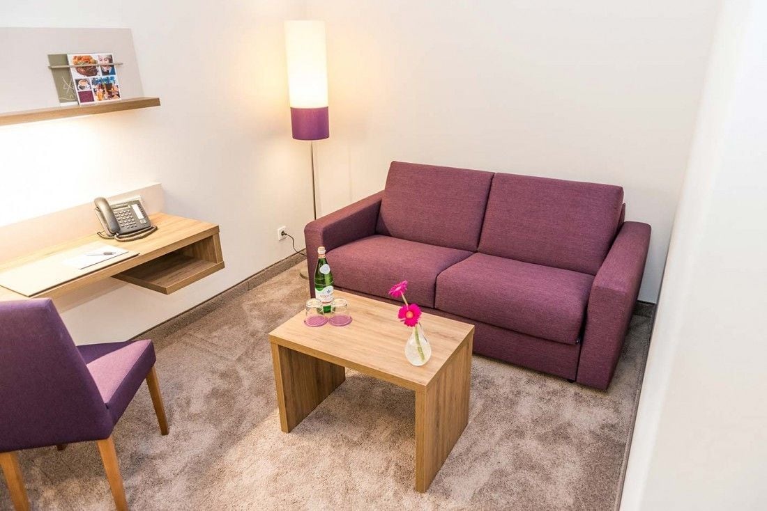 deluxe double room | living area | plasma tv