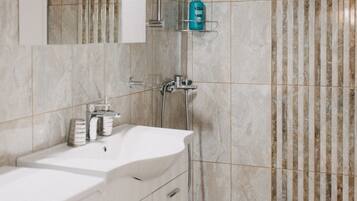 Shower, hair dryer, slippers, towels