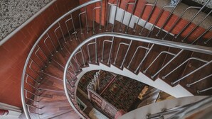 Eine Wendeltreppe mit Metallgeländern und Holzstufen.