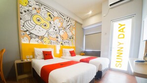 A hotel room with two beds, a colorful mural on the wall, a 'Sunny Day' sign, and a wooden floor. - RedDoorz Apartment near Bundaran Satelit Surabaya (Surabaya)