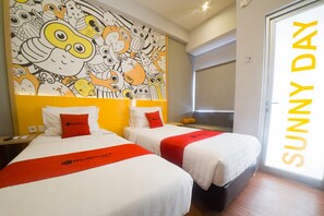 A hotel room with two beds, a colorful mural on the wall, and a 'Sunny Day' sign. - RedDoorz Apartment near Bundaran Satelit Surabaya (Surabaya)