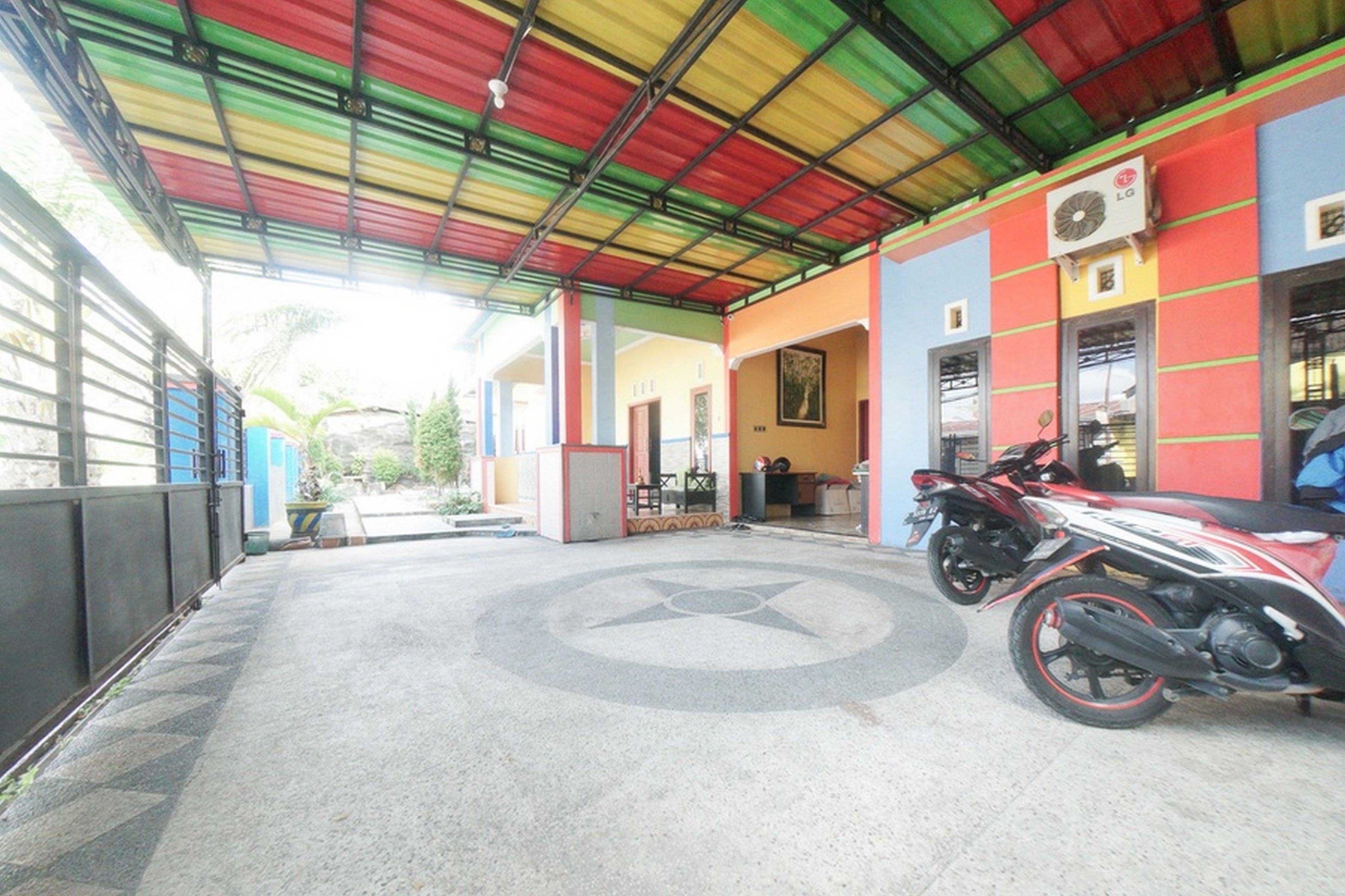 A covered parking area with colorful walls and a star-shaped floor design.