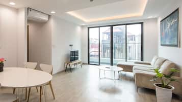 Superior Apartment, 2 Bedrooms | Living room | 49-inch TV with cable channels