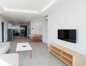 Deluxe Apartment | Living area | 49-inch TV with cable channels