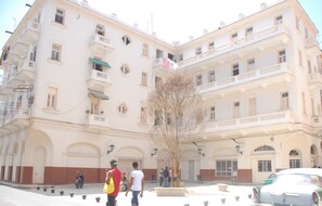 A multi-story building with balconies and arched windows. - Alameda dePaula (Havana)