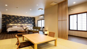A hotel room with two beds, a dining table, chairs, a sofa, and a sliding door. - Kinosaki Onsen Ryokan Oyado Hakusan (Toyooka)