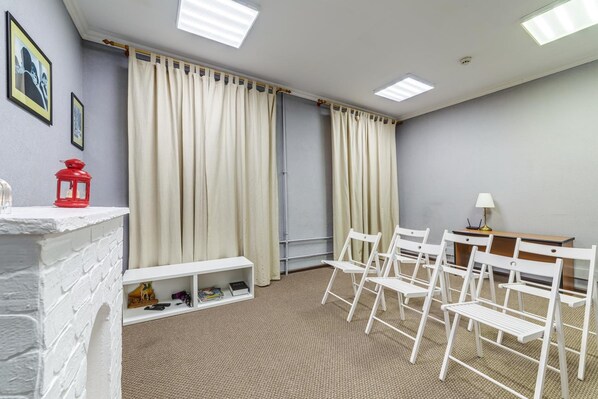 Cozy room with a brick fireplace, bench, and comfortable seating area.