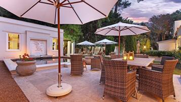 Relax in style on this well-appointed patio, complete with wicker furniture and a table for dining or socializing.
