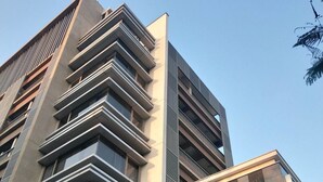 A modern high-rise building with a unique architectural design, featuring multiple balconies and large windows. - Shine Residence (Taichung)