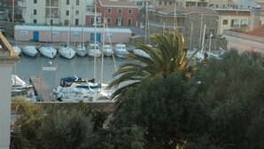 A marina with multiple boats docked, surrounded by residential buildings.