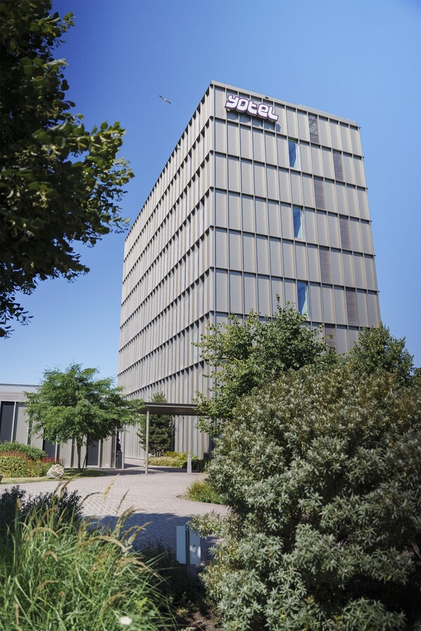A modern building with a grid-like facade and a sign that reads 'Yotel'. - YOTEL Amsterdam (Amsterdam)