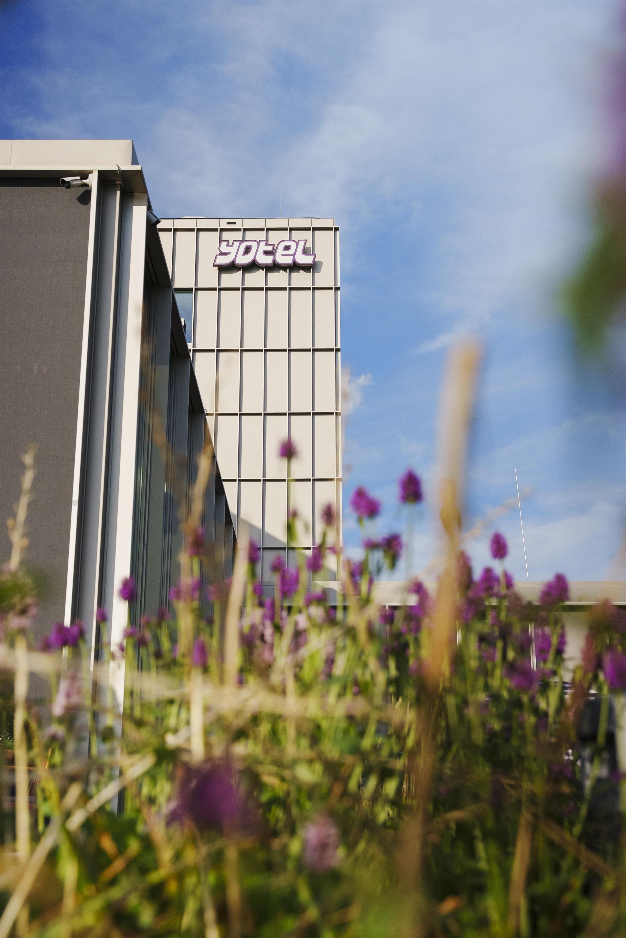 A modern building with a sign that reads 'yotel'.
