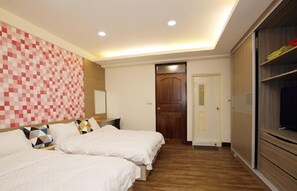 A hotel room with two beds, a wooden floor, a wall with a pixelated pattern, and a wardrobe with a TV. - Jushan 93 House (Zhushan)