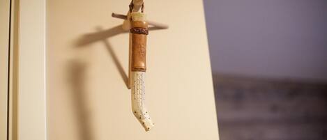 A door handle with a carved wooden handle and a brass lever.