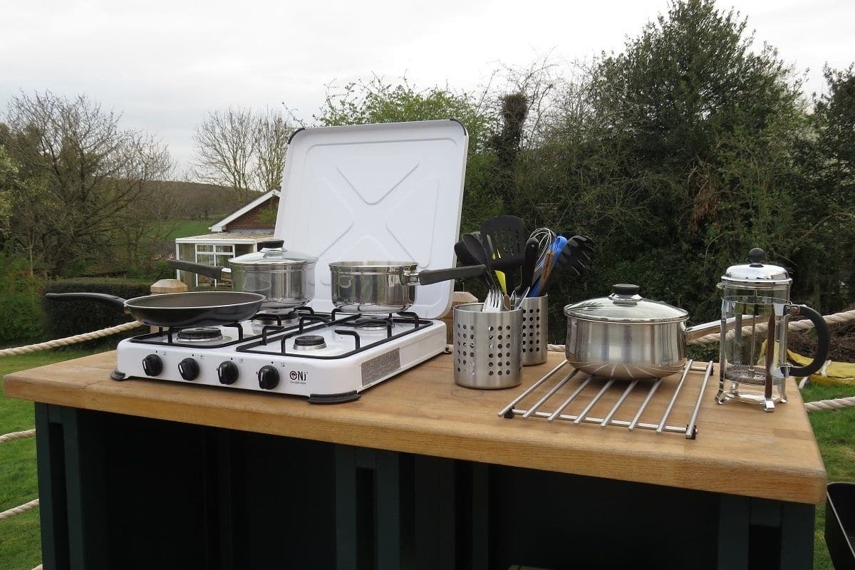 Frigorífico grande, placa de cocina y utensilios de cocina