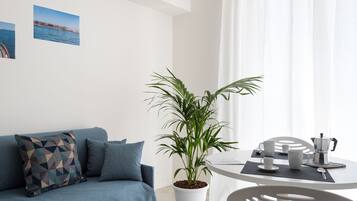 Apartment, 1 Bedroom, Balcony (Dionisio) | Living room | Flat-screen TV