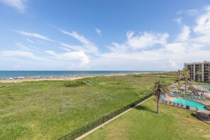 A resort with a pool, beach, and ocean view. - Saida I #405 | Upscale Beachfront Condo • Gulf Views • 3 Resort Pools (South Padre Island)