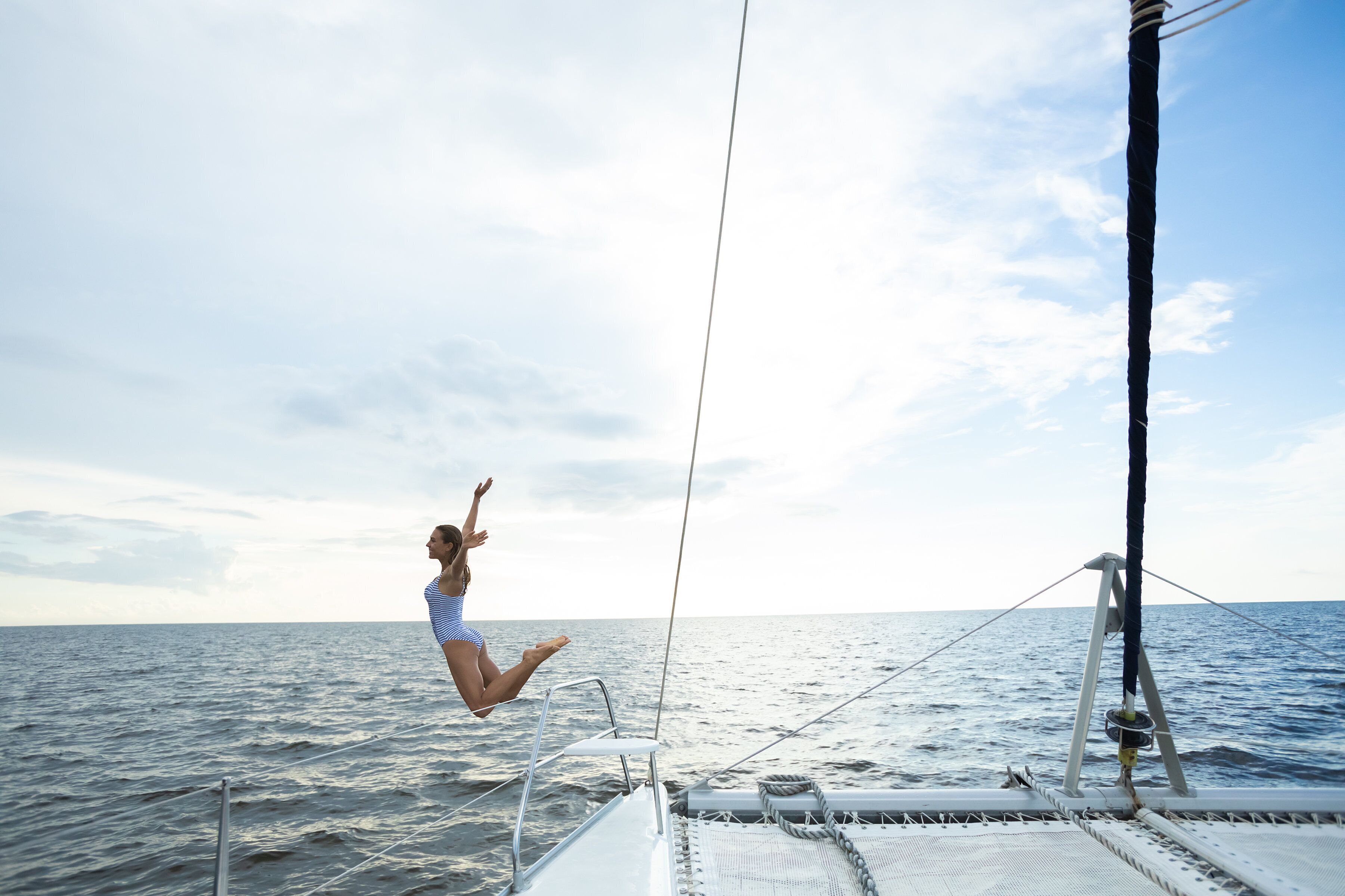 A person jumping off a boat into the sea.