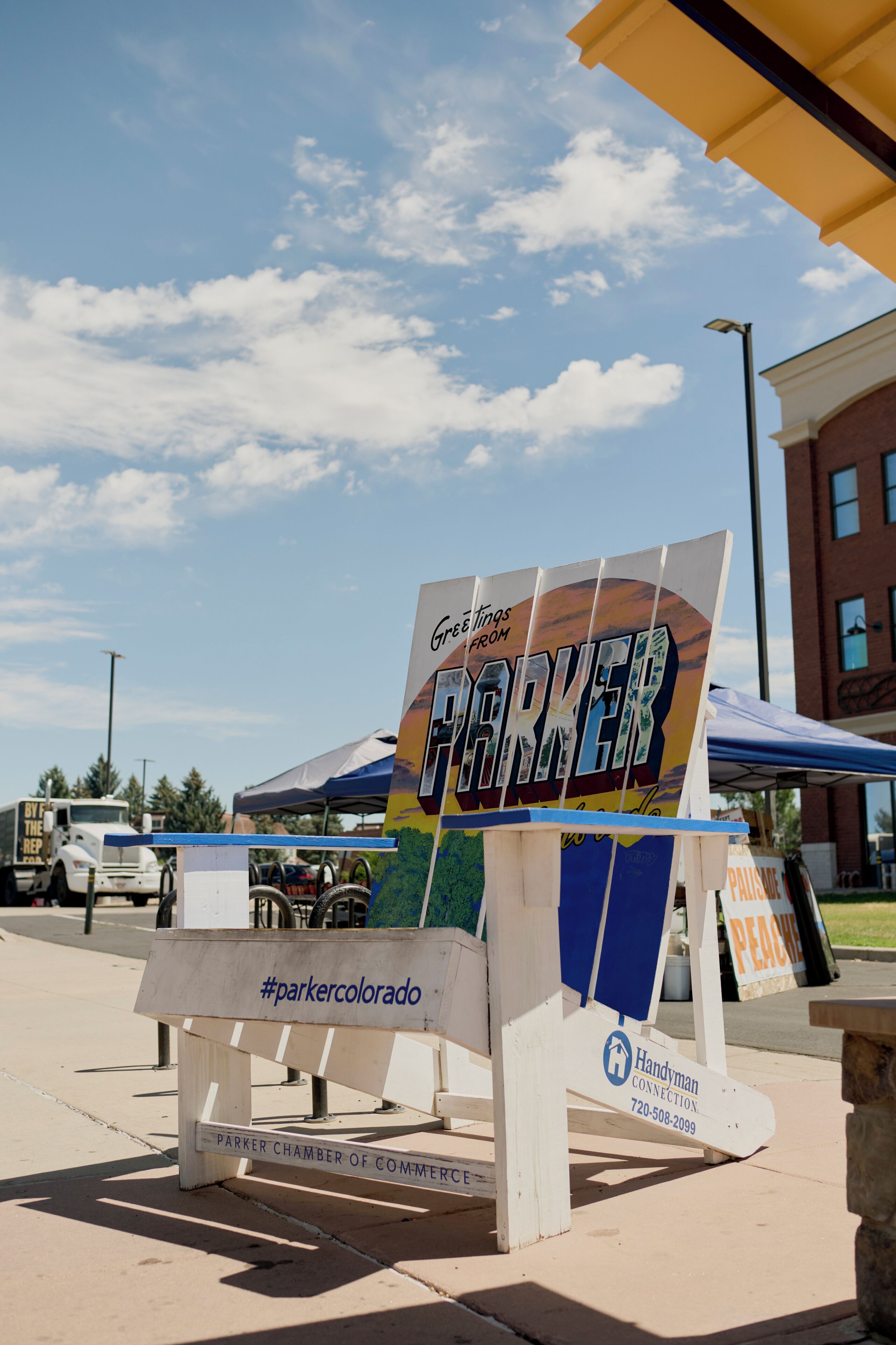 A sign for the Parker Chamber of Commerce with a hashtag #parkercolorado.