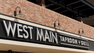 A brick building with a sign that reads 'WEST MAIN TAPROOM + GRILL'.