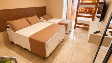 A hotel room with two beds, a desk, a chair, a TV, and a bathroom with a shower.