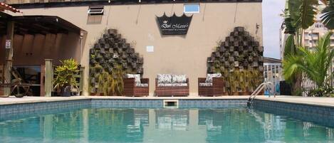 Outdoor pool, open 10:00 AM to 10:00 PM, pool umbrellas, pool loungers