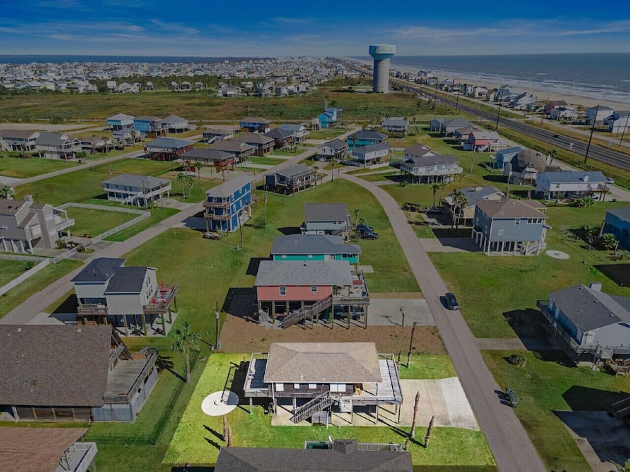 An aerial view of a residential area with houses, roads, and a water tower.
