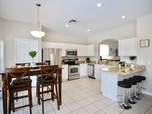 Enjoy cooking and dining in this well-equipped kitchen with a central island and dining area.