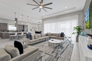 Elegant Estate with Private Pool & Shuffleboard near Disney with Waterpark Access | Living area | 42-inch flat-screen TV with cable channels, TV - The Bear's Den Resort Orlando (Kissimmee)