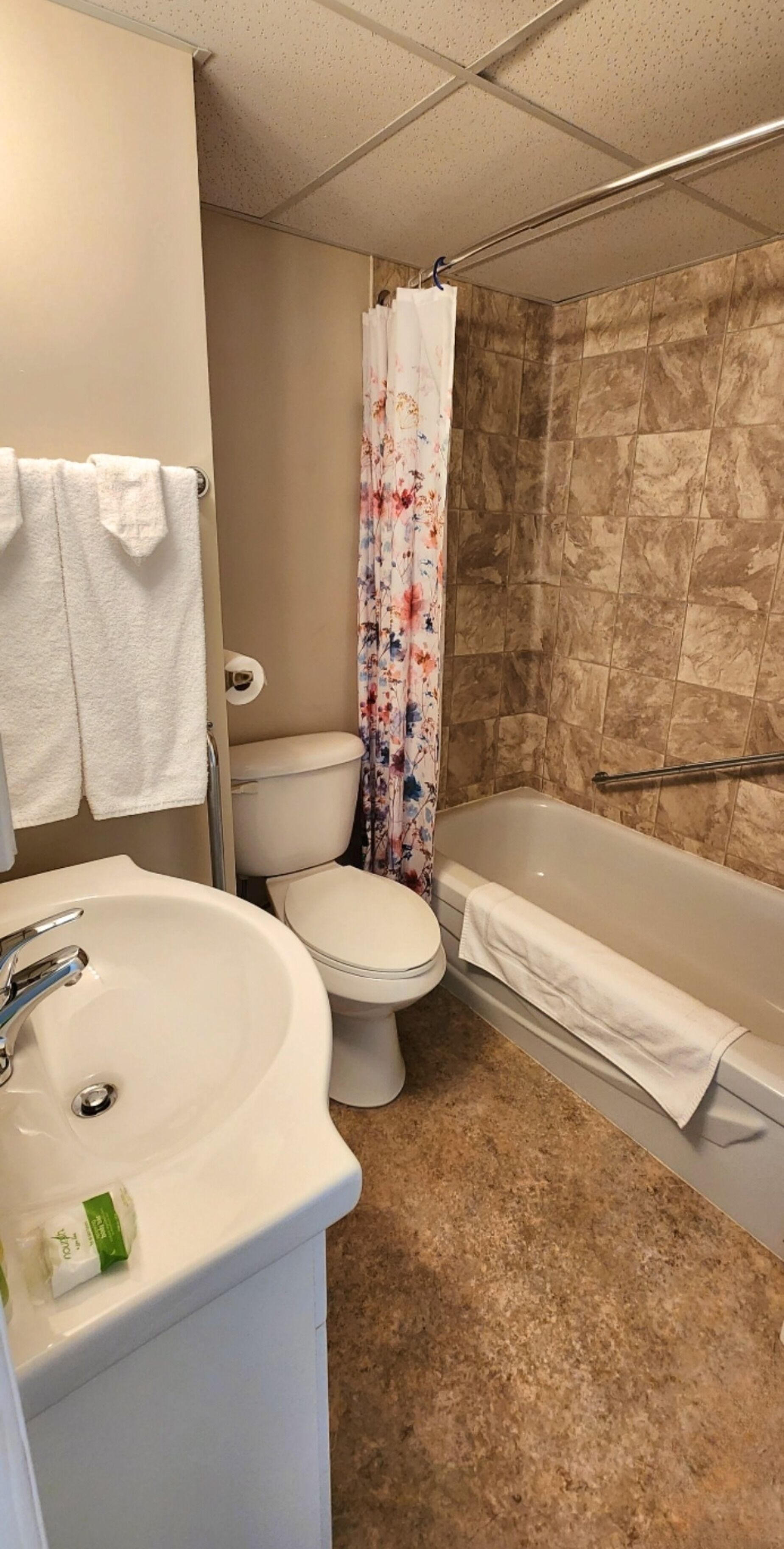 A bathroom with a sink, toilet, and bathtub.