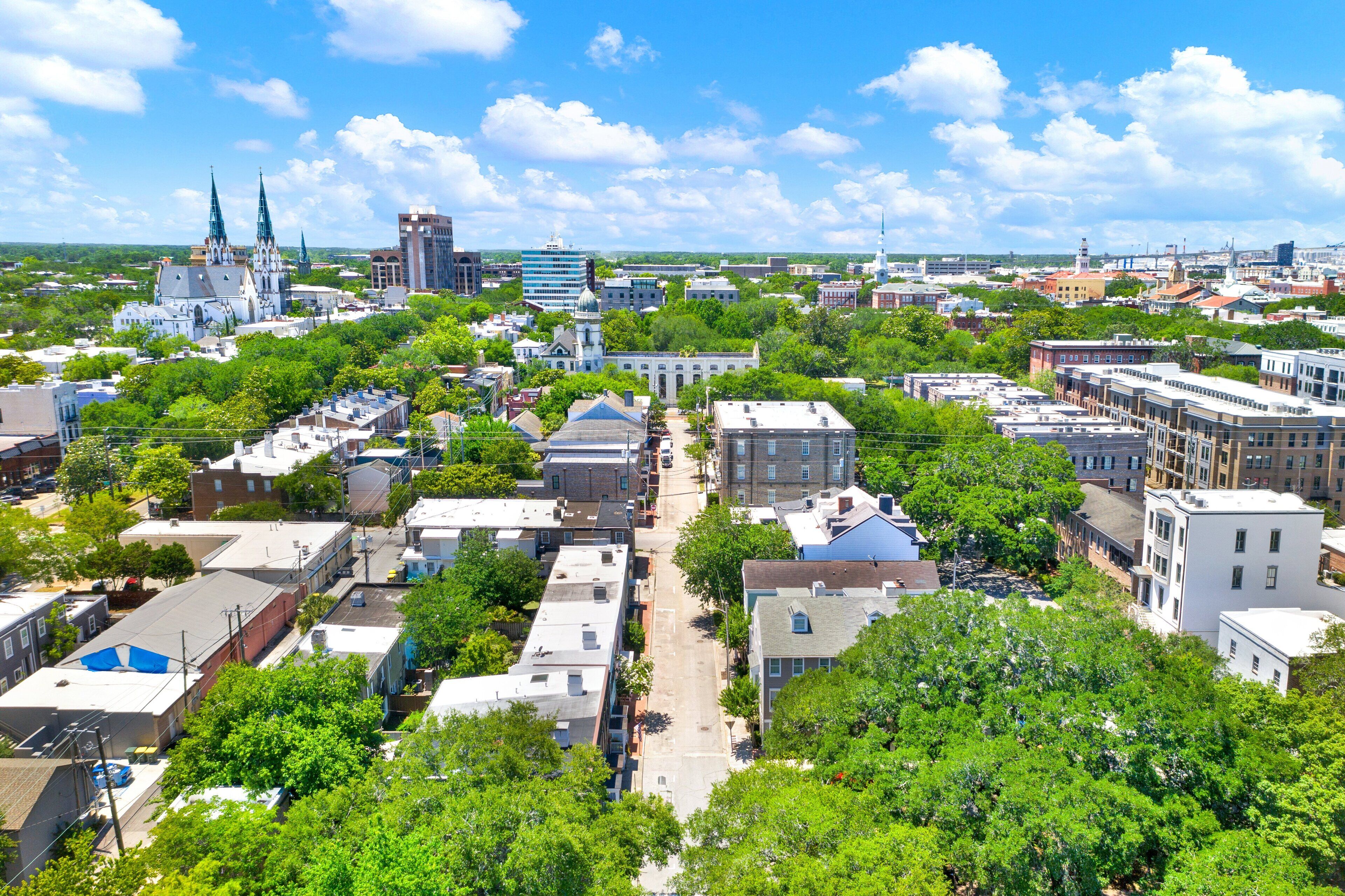 A cityscape with various buildings, including a prominent church with two spires, and a mix of residential and commercial structures.