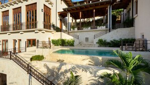 A multi-story building with a pool, outdoor seating, and a covered patio area. - Oceanfront•Sleeps 6•Full Kitchen•BBQ•Pool•Balcony - Alouatta Guesthouse (Las Catalinas)