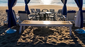 A beach tent with a table and chairs, overlooking the ocean. - Ballard's (Block Island)