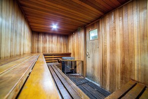 A sauna with wooden benches and a bench heater. - Perfect Family 2 Bedroom at Canyon Lodge & Village, Sleeps 6+! WIFI & HOT TUB (Mammoth Lakes)